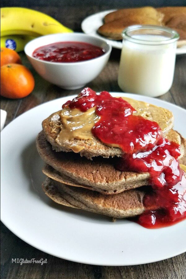 Fluffy gluten free Buckwheat pancakes covered in homemade strawberry sauce