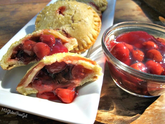 gluten-free cherry hand pies pouring with cherries