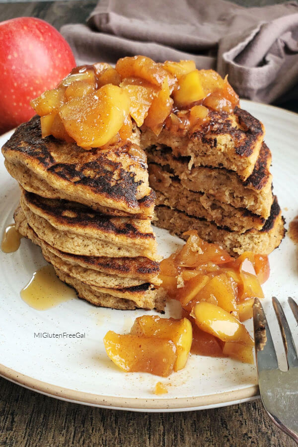 gluten free apple pie spice pancakes topped with cooked apples