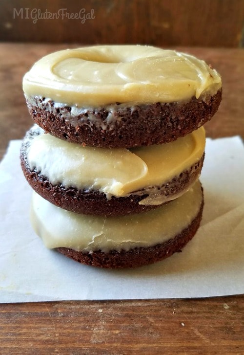 gluten-free chocolate sunbutter donuts stacked on parchment paper