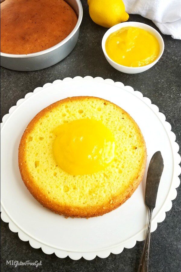 homemade lemon curd on bottom layer of cake