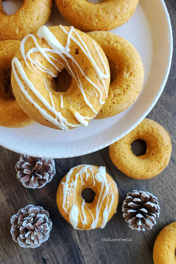 baked gluten free pumpkin donuts drizzled with white chocolate