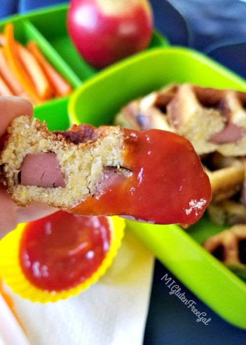 gluten-free corn dog waffles dipped in ketchup
