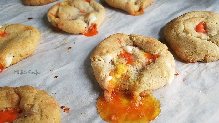 Gluten Free White Chocolate Candy Corn Cookies on baking sheet melted