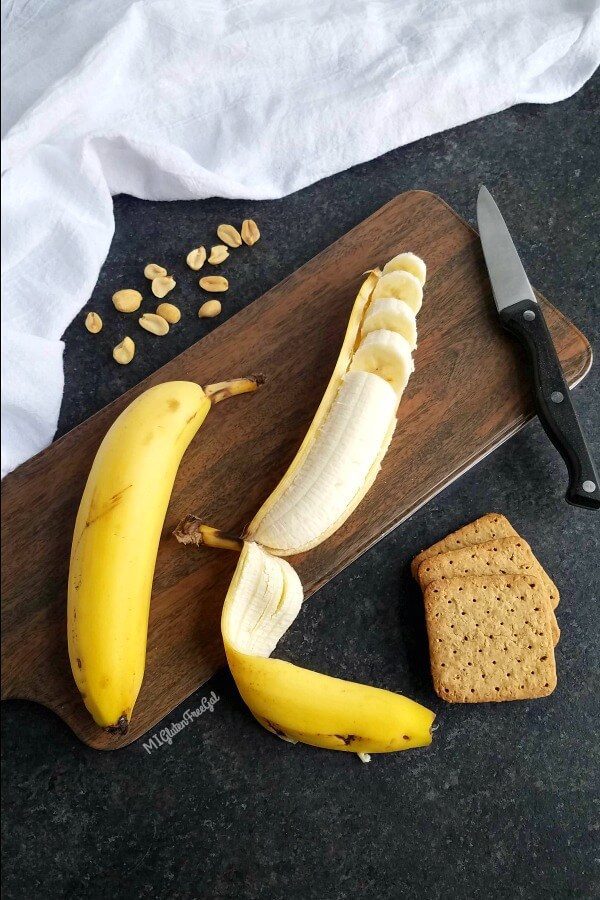 gluten free peanut butter pie shake with cut banana on cutting board