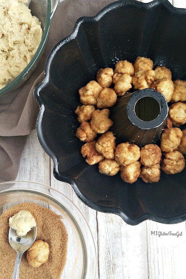 gluten free monkey bread rolling dough bites in cinnamon and sugar