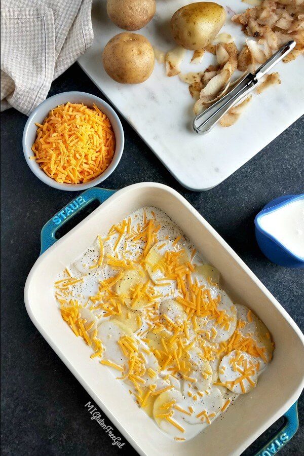 Building your Gluten Free Au Gratin Potatoes in a casserole dish