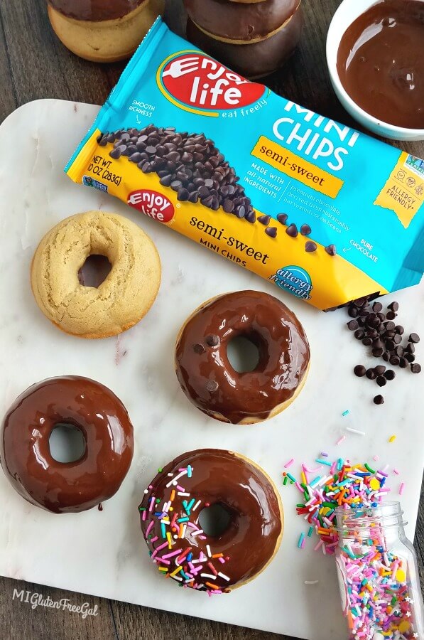 gluten free vegan chocolate dipped donuts on marble cutting board with Enjoy Life Foods Chocolate chips