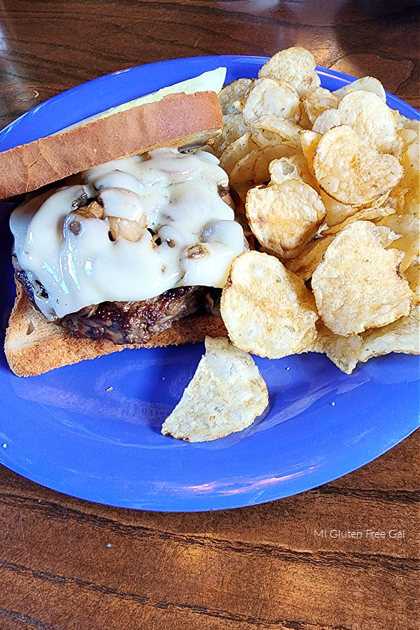 Gluten Free burger and potato chips. Purple plates denote a gluten free/ food allergy order