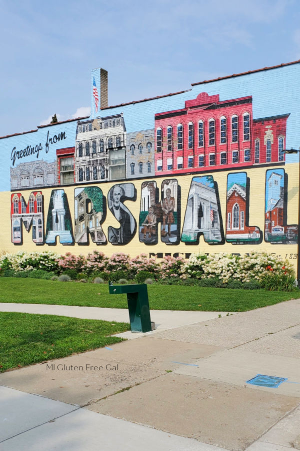 Building mural that states "Greetings from Marshall" in Michigan